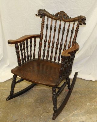 Antique Victorian Oak Rocking Chair – With Spindles Carved Dolphin