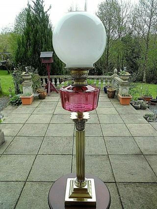 A Victorian Cranberry Twin Duplex Table Oil Lamp.