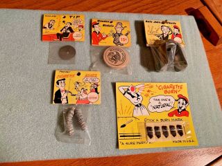 5 Vintage Fun Inc.  Rack Items - Cigarette Ashes,  Wooden Nickle,  Auto Whistle,