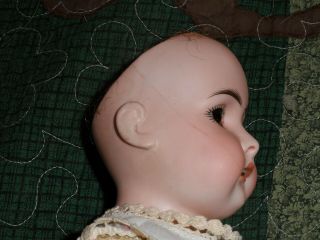 ANTIQUE GERMAN DOLL marked 7,  has hairline,  kid skin body,  16 