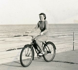 Vintage B/w Photo Snapshot Of A Woman Riding Her Bike Along The Ocean Coast