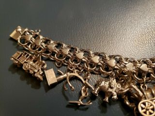 Vintage Sterling Silver Charm Bracelet with 15 silver charms weighing 65g and 8 