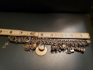 Vintage Sterling Silver Charm Bracelet with 15 silver charms weighing 65g and 8 
