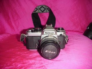 Nikon Fe 35mm Film Slr Camera Body Nikkor 24mm 1:2.  8 50mm 1:1.  4 W/strap Manuals