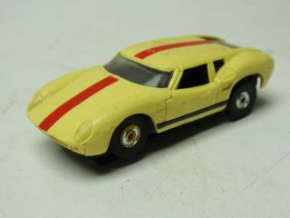 Vintage Aurora Slot Car Ford Lola Race Car Yellow With Racing Red Stripes.