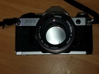Canon AE - 1 Program 35mm SLR Film Camera w/FD 50mm Lens 1:1.  4 S.  S.  C 55mm Sky A 7