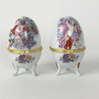 2 Vintage Porcelain Eggs Jewelry Hinged Footed Trinket Box Cherubs Angel Easter