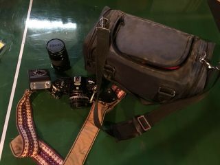 Nikon Em Camera With Extra Lense,  Flash,  Strap,  And Travel Bag