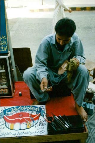 A " Dentist " With A Practice On The Street In Pakistan.  - Vintage Photo