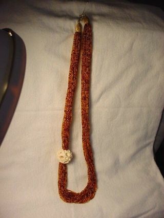Vintage Amber Beaded Necklace With A Carved Bone Ball.