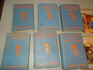 7 Vintage Nancy Drew books,  1930s editions,  blue covers w/ orange silhouette 2