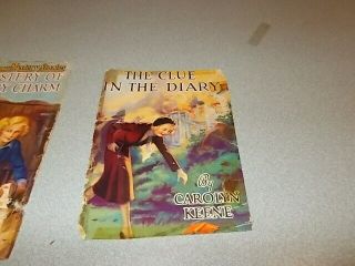 7 Vintage Nancy Drew books,  1930s editions,  blue covers w/ orange silhouette 7