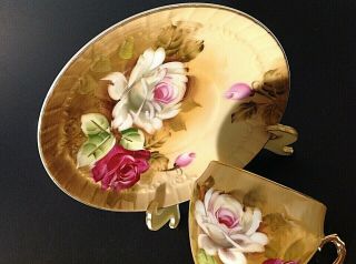 VINTAGE PEDESTAL CUP & SAUCER.  HAND PAINTED.  RED & WHITE ROSES.  GOLD ACCENTS 8