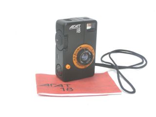 Agat - 18k 35mm Half - Frame Camera.  Black Body,  Orange Front.