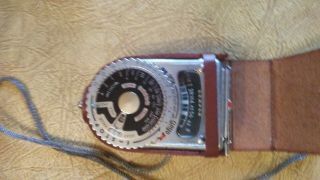 Movie camera and accessories.  Revere 8 Model 67.  Film and light meter 2