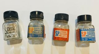Four (4) Vintage Lionel Post War Bottles With Sp Smoke Unit Pellets