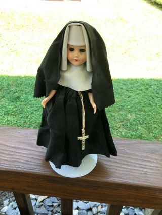 Vintage Nun Doll Celluloid Plastic Dressed In Black Sleepy Eyes & Crucifix.