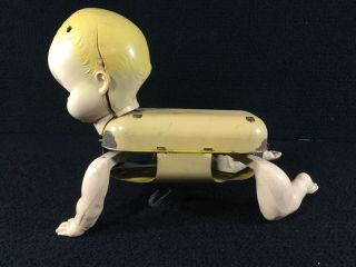 VINTAGE CELLULOID & TIN MECHANICAL CRAWLING BABY WIND UP TOY.  DETACHED ARM 5