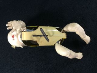 VINTAGE CELLULOID & TIN MECHANICAL CRAWLING BABY WIND UP TOY.  DETACHED ARM 8