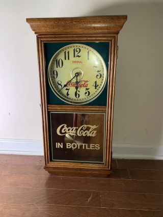 Vintage Coca Cola Wall Clock With Pendulum.  Drink Coca Cola In Bottles Edition.