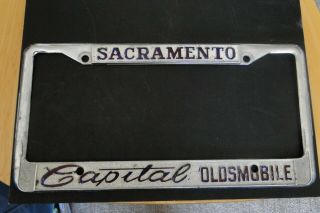 Vintage Sacramento Capital Oldsmobile Dealership License Plate Frame Metal Rare