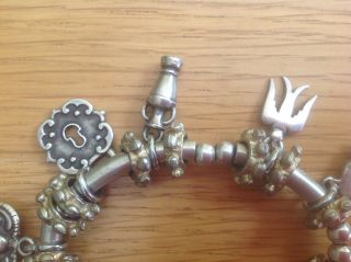 An Unusual Vintage Silver - Toned Charm Bracelet with 10 unusual Charms 5