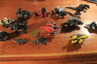 13 Mini Dinosaur Plastic Figures 1 " To 2” Long With Weapons Attached.