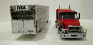 1/64 DCP Diecast Promotion Red Volvo VNL 670 Cow Catcher with cattle trailer 3