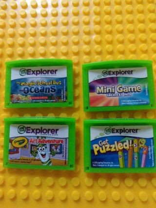 Four Leapster Explorer Leap Frog Game Cartridges.  " Magic School Bus,  Crayola Etc