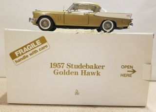 Danbury 1957 Studebaker Golden Hawk Coupe.  And Paper.