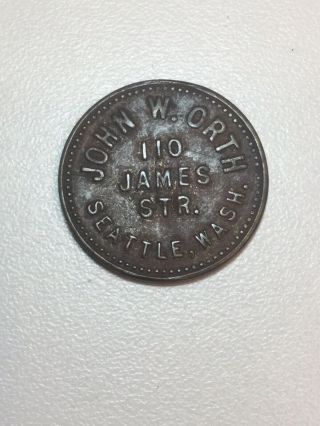 John W.  Orth/ 110 James Seattle,  Wash.  Good For/a/ (bit).  Store Token
